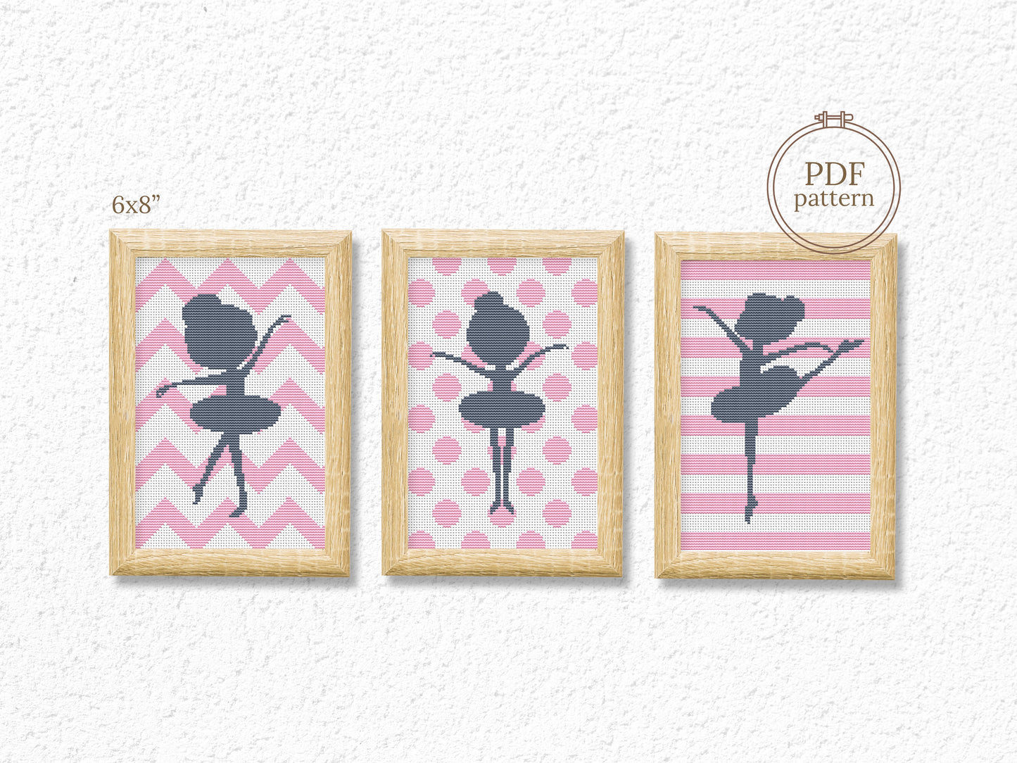 Three framed cross-stitch patterns of a ballerina on pink backgrounds with wooden frames.