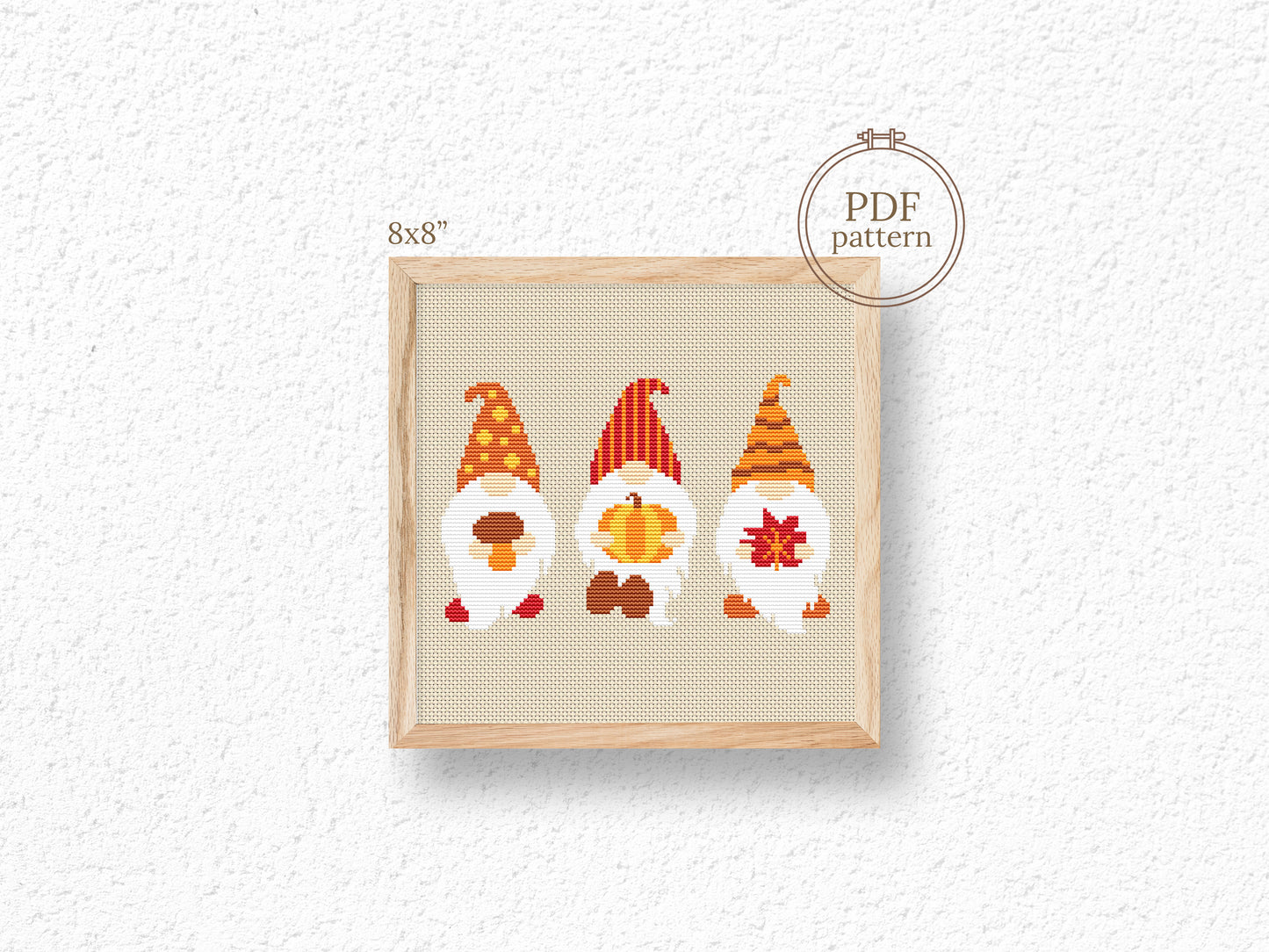 Cross-stitch pattern with three colorful gnomes on a white background
