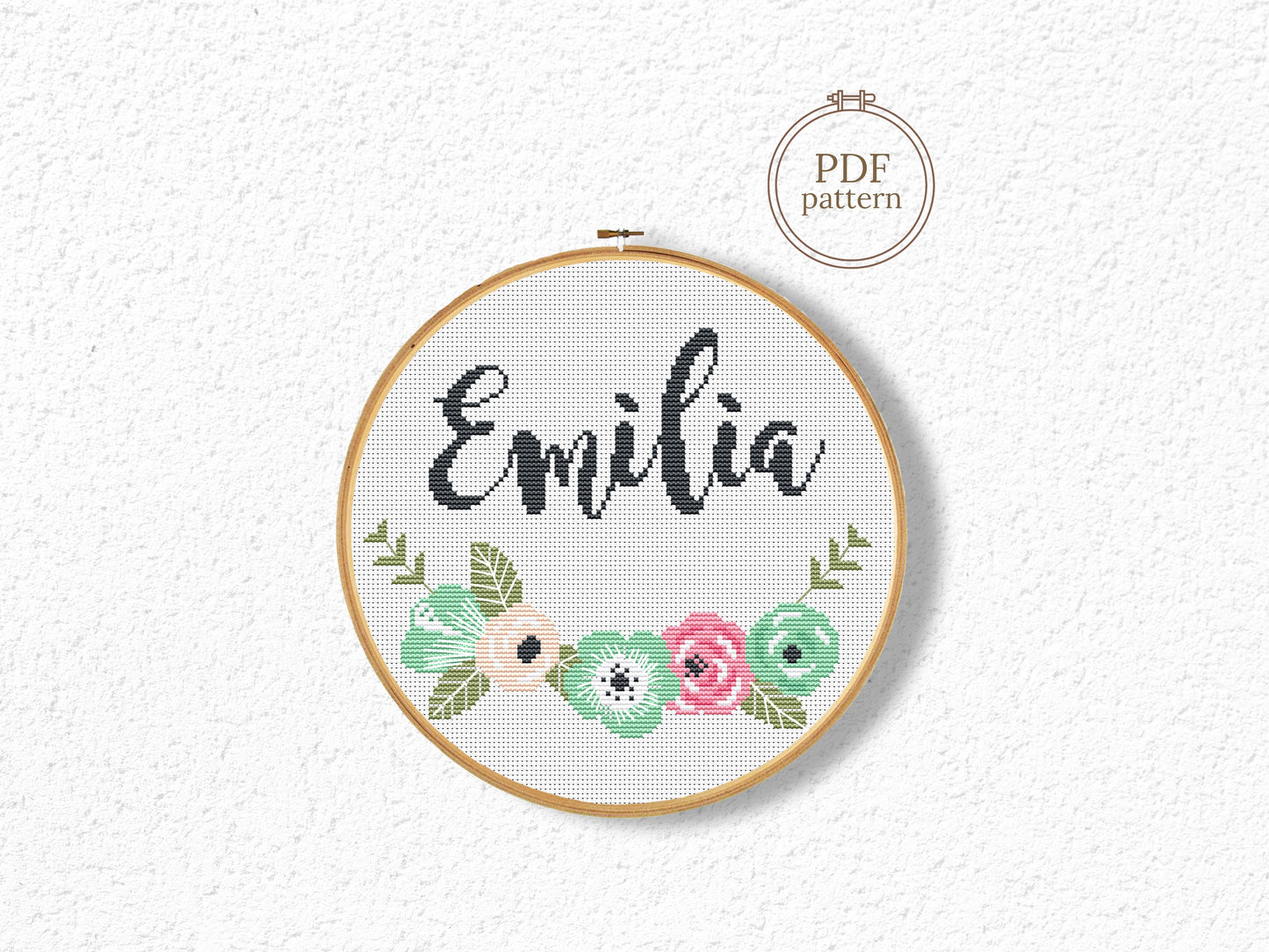 Custom name cross stitch pattern with floral branch below and personalized name on top, minimal floral embroidery design