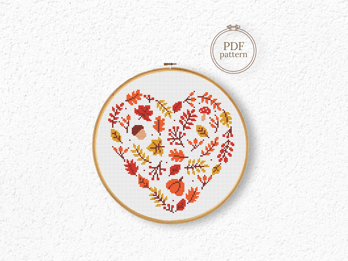 Heart-shaped autumn cross stitch pattern with fall leaves, cozy seasonal PDF design
