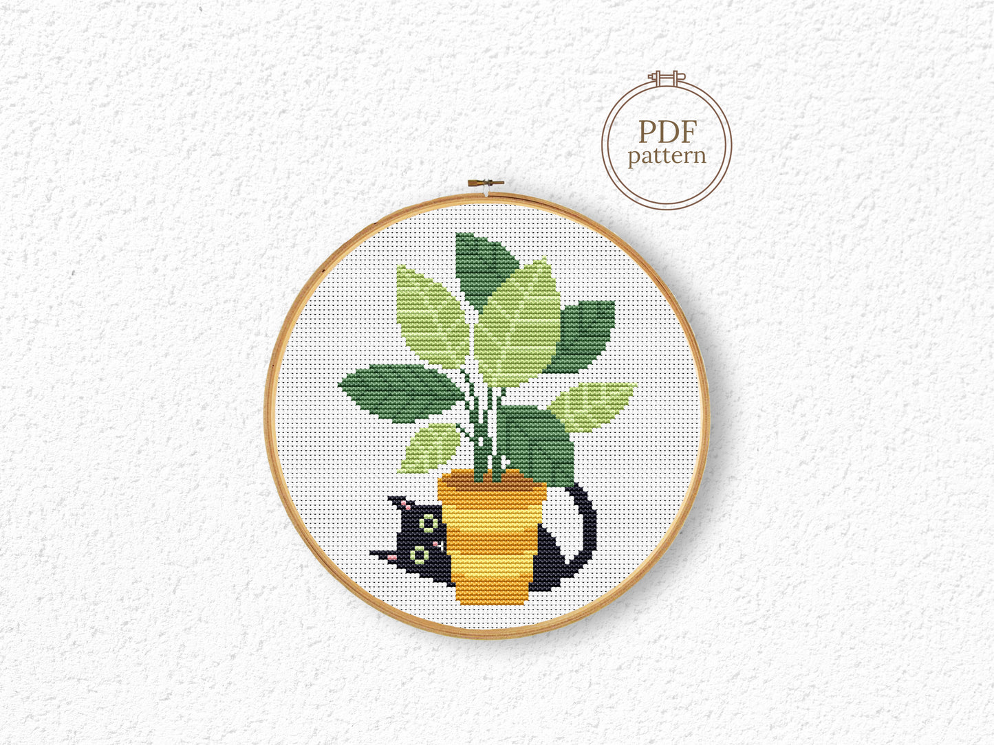 Black cat cross stitch pattern sitting in a flower pot, cozy and expressive design
