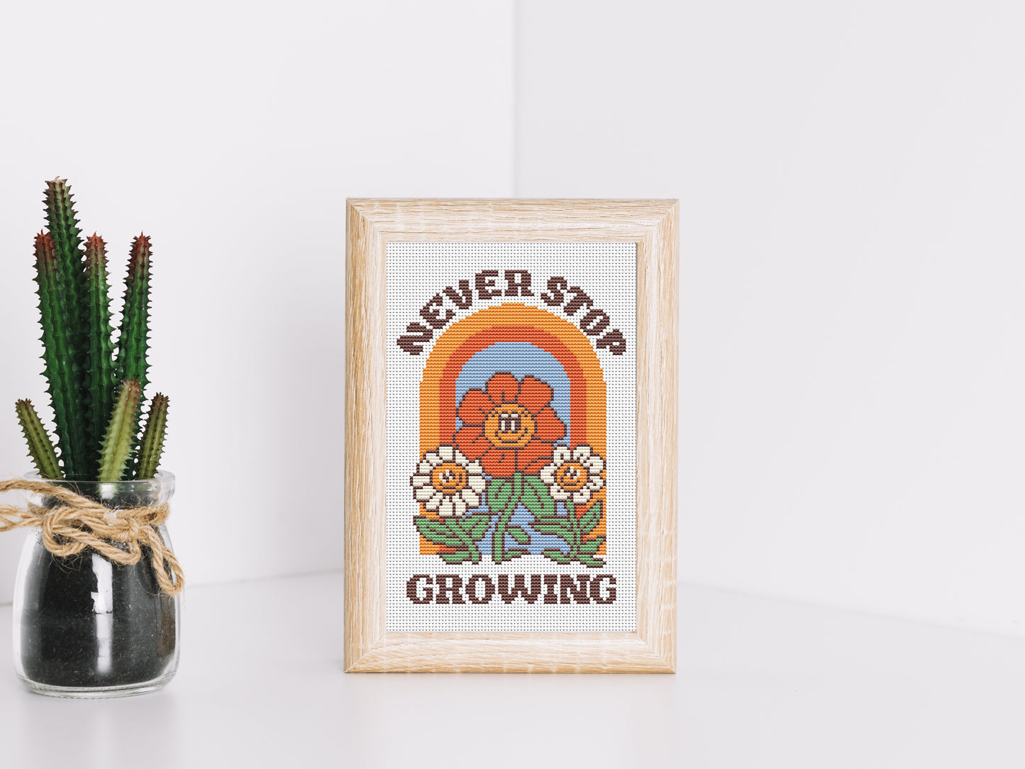 Never Stop Growing cartoon quote cross stitch pattern with retro colors – PDF download.