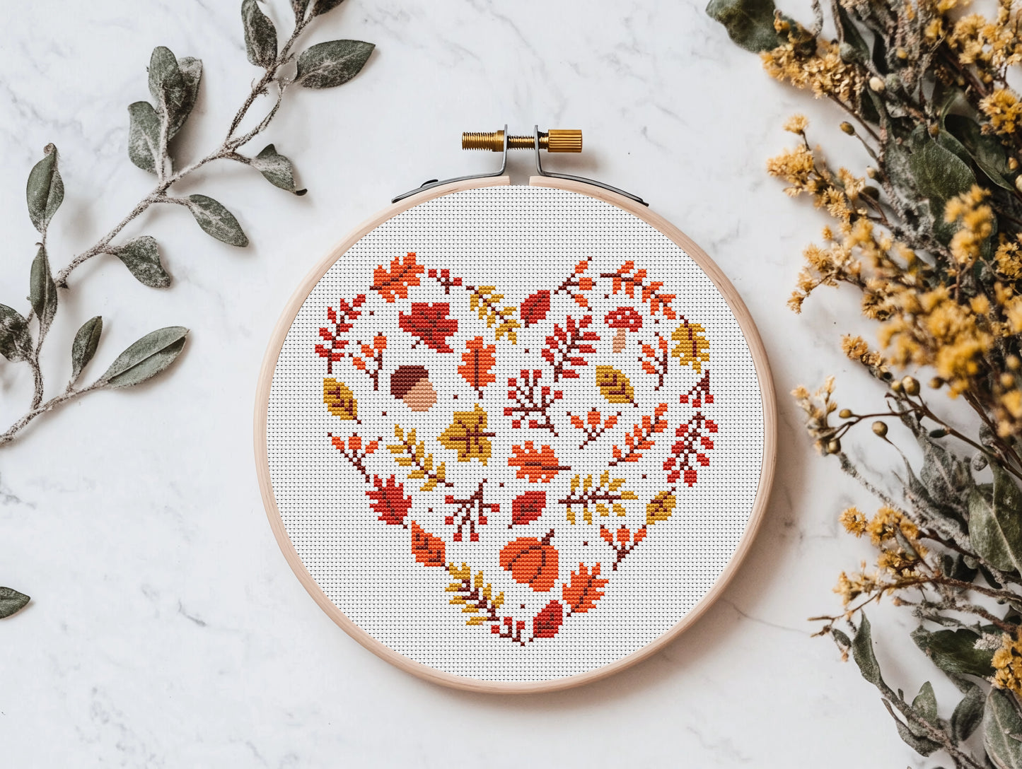 Heart-shaped autumn cross stitch pattern with fall leaves, cozy seasonal PDF design