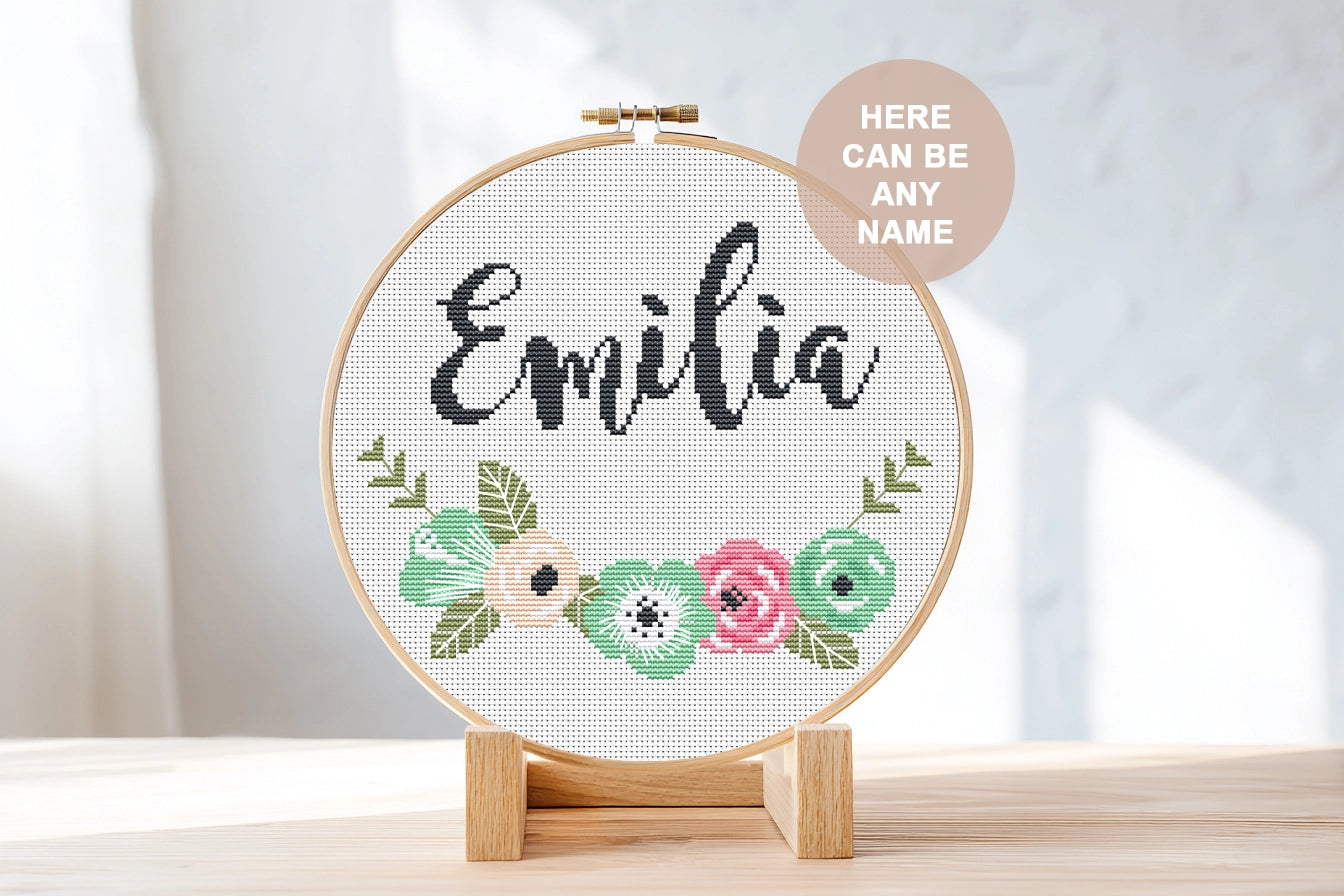 Custom name cross stitch pattern with floral branch below and personalized name on top, minimal floral embroidery design