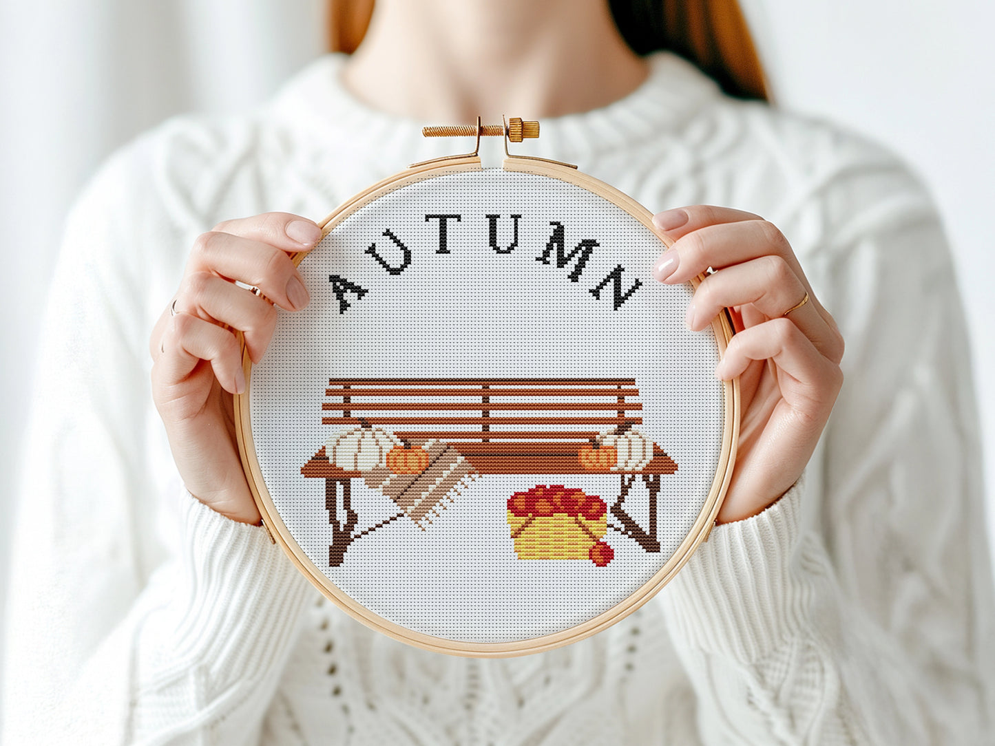 Cross stitch pattern with pumpkins on a bench and "Autumn" text, rustic cozy fall PDF design