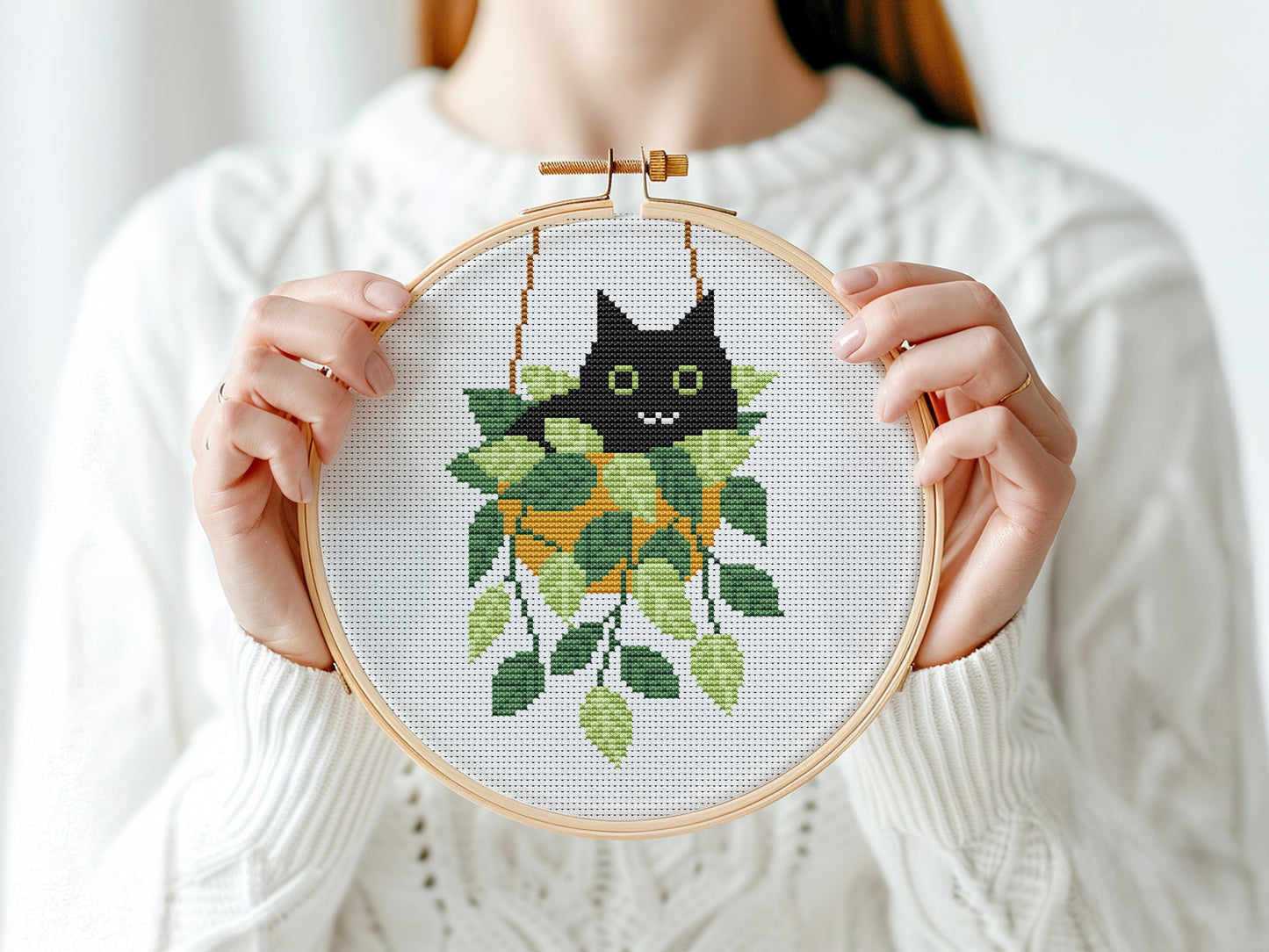Cute relaxed cat cross stitch pattern sitting in plant pot, peaceful and cozy design