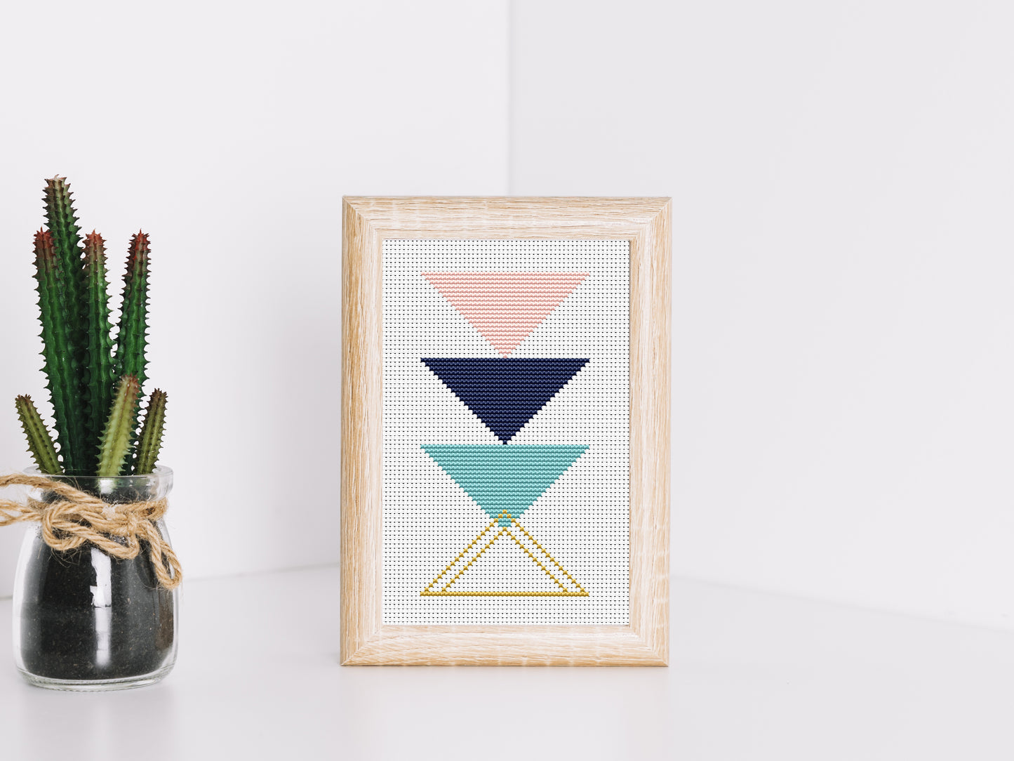 Triangle blue and rose gold abstract cross stitch pattern with modern geometric design