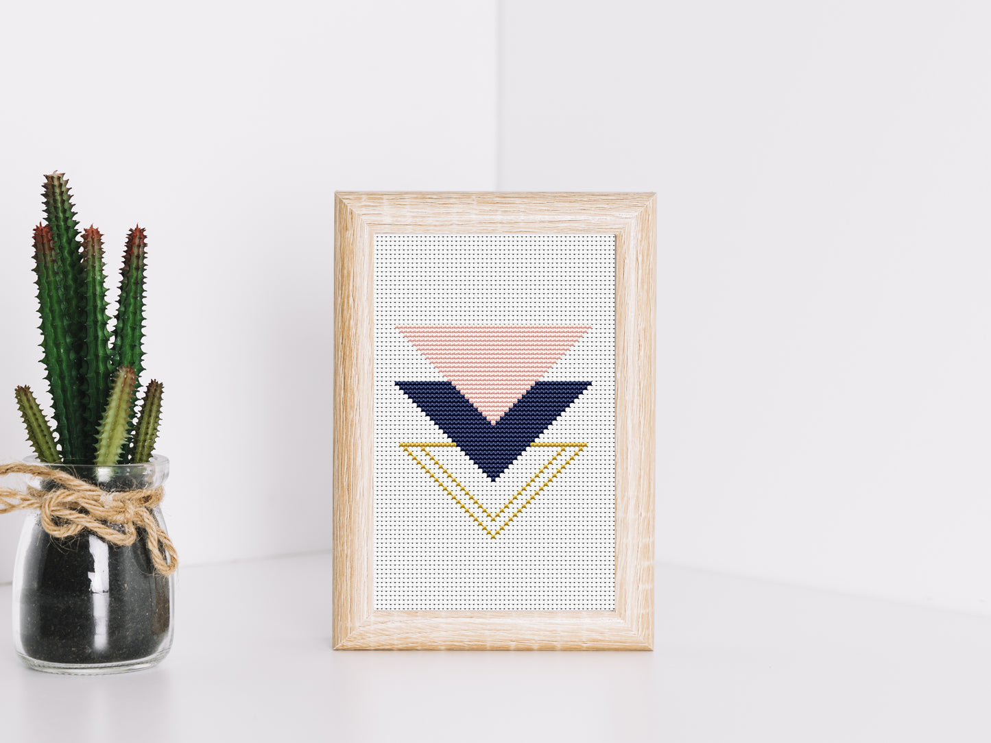 Triangle rose and gold cross stitch pattern with geometric and floral design