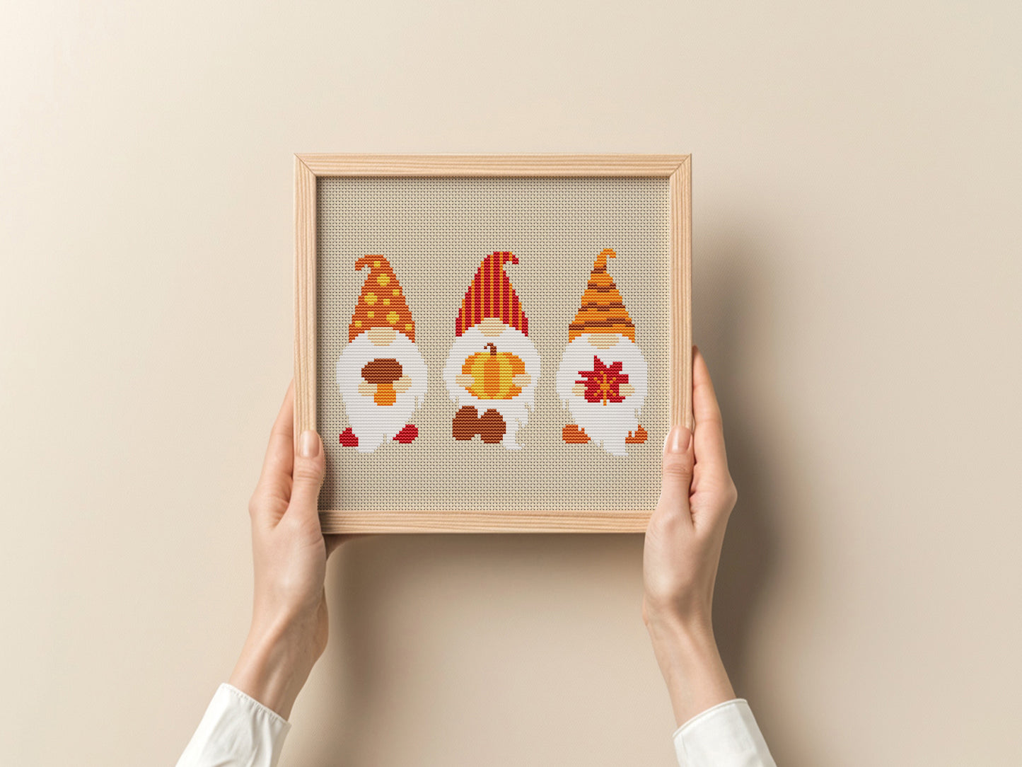 Framed artwork with three gnomes on a beige background