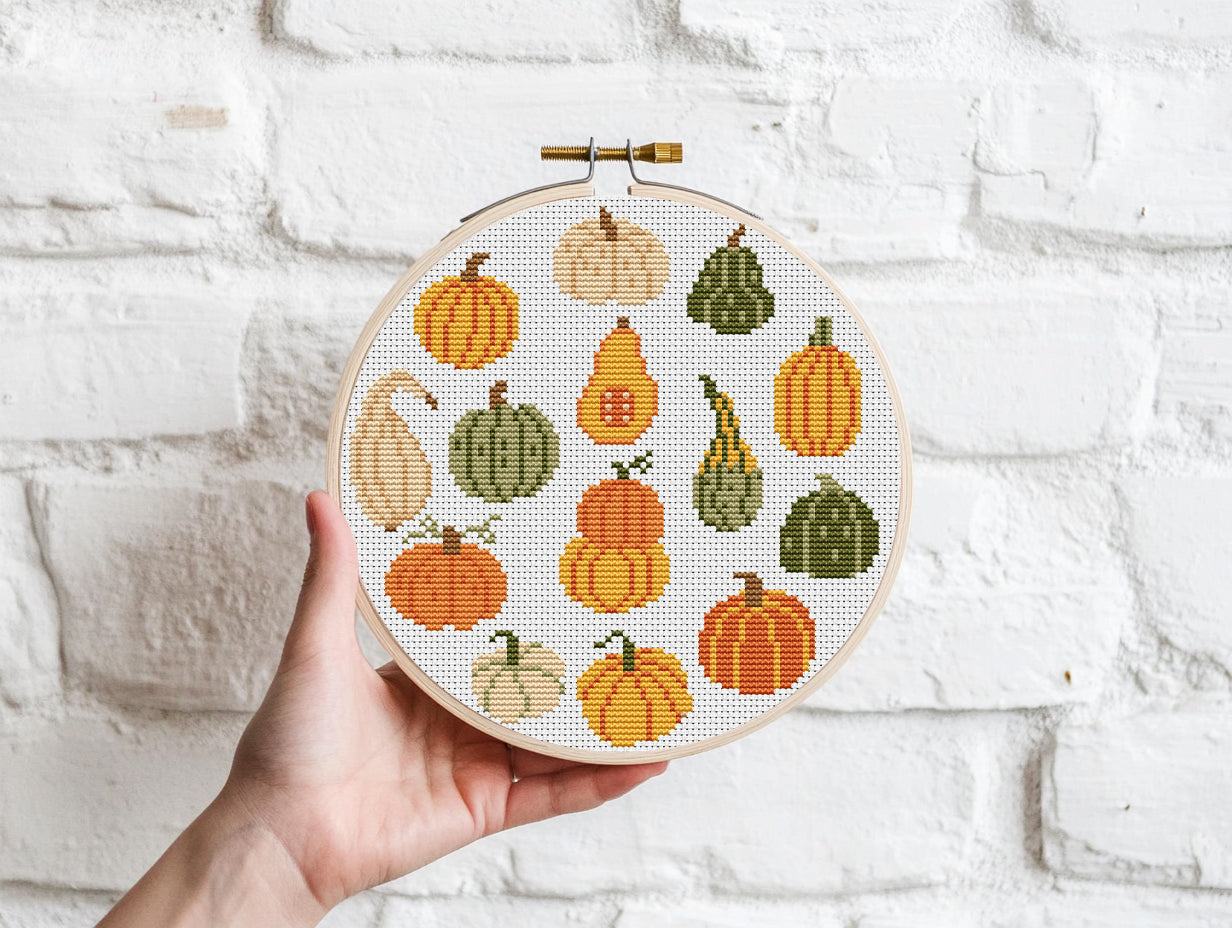 Fall cross stitch pattern with colorful pumpkins in different shapes and autumn shade