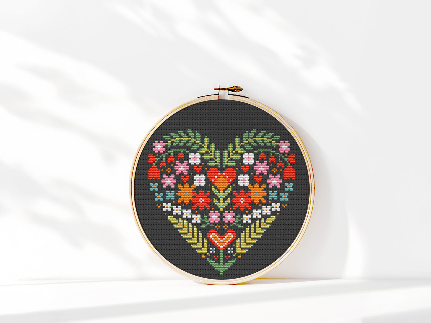 Folk Floral heart cross stitch pattern on black Aida fabric