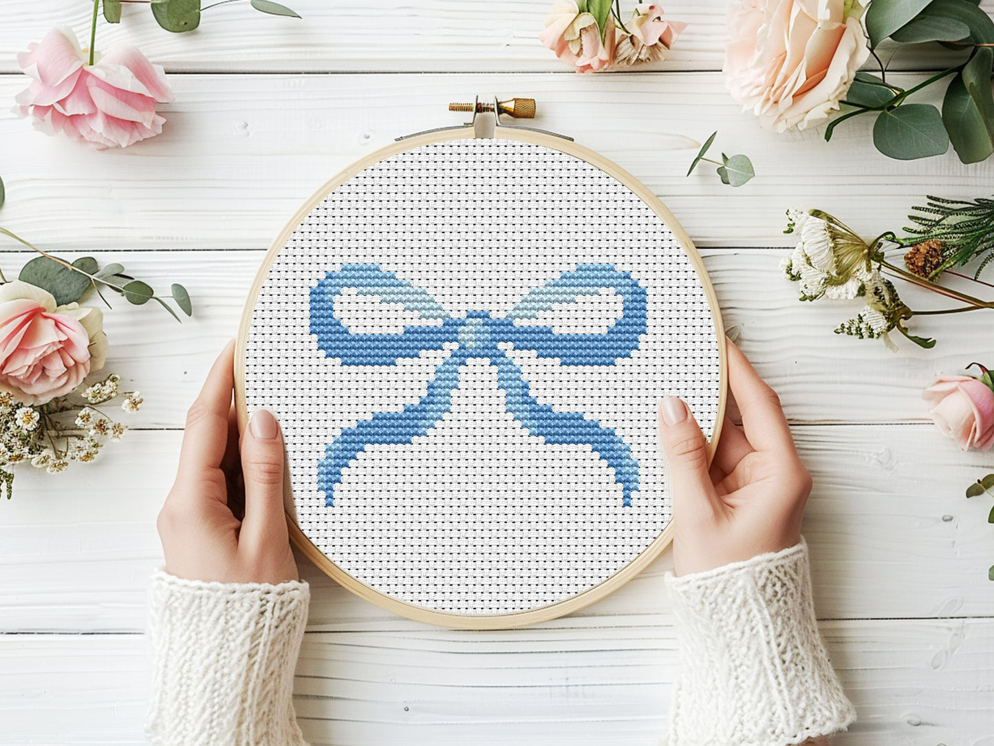 Cute blue bow cross stitch pattern for modern girl room decor.