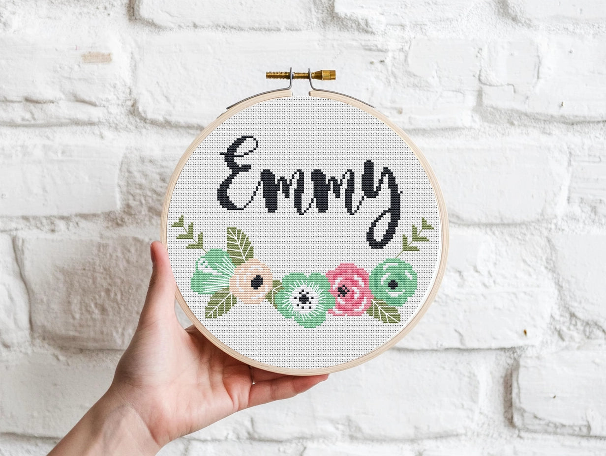 Custom name cross stitch pattern with floral branch below and personalized name on top, minimal floral embroidery design