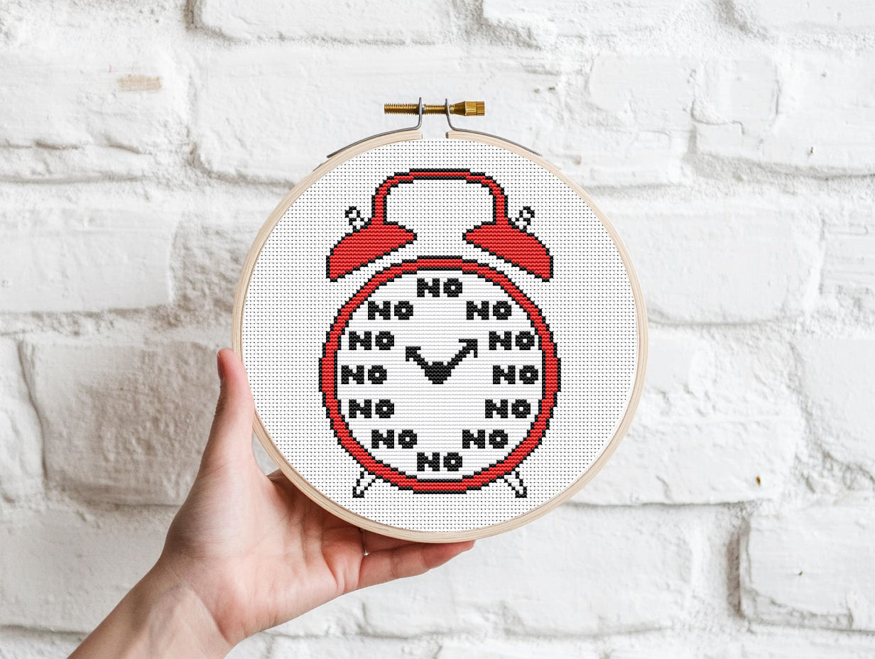 Funny alarm clock cross stitch pattern with playful design