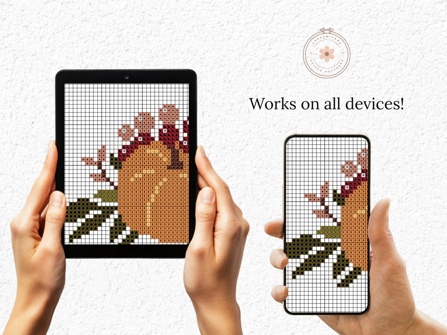 Two hands holding a tablet and phone displaying a cross-stitch pattern of a pumpkin.