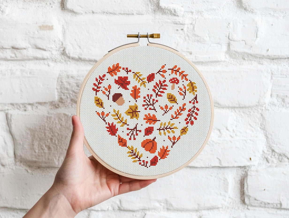 Heart-shaped autumn cross stitch pattern with fall leaves, cozy seasonal PDF design