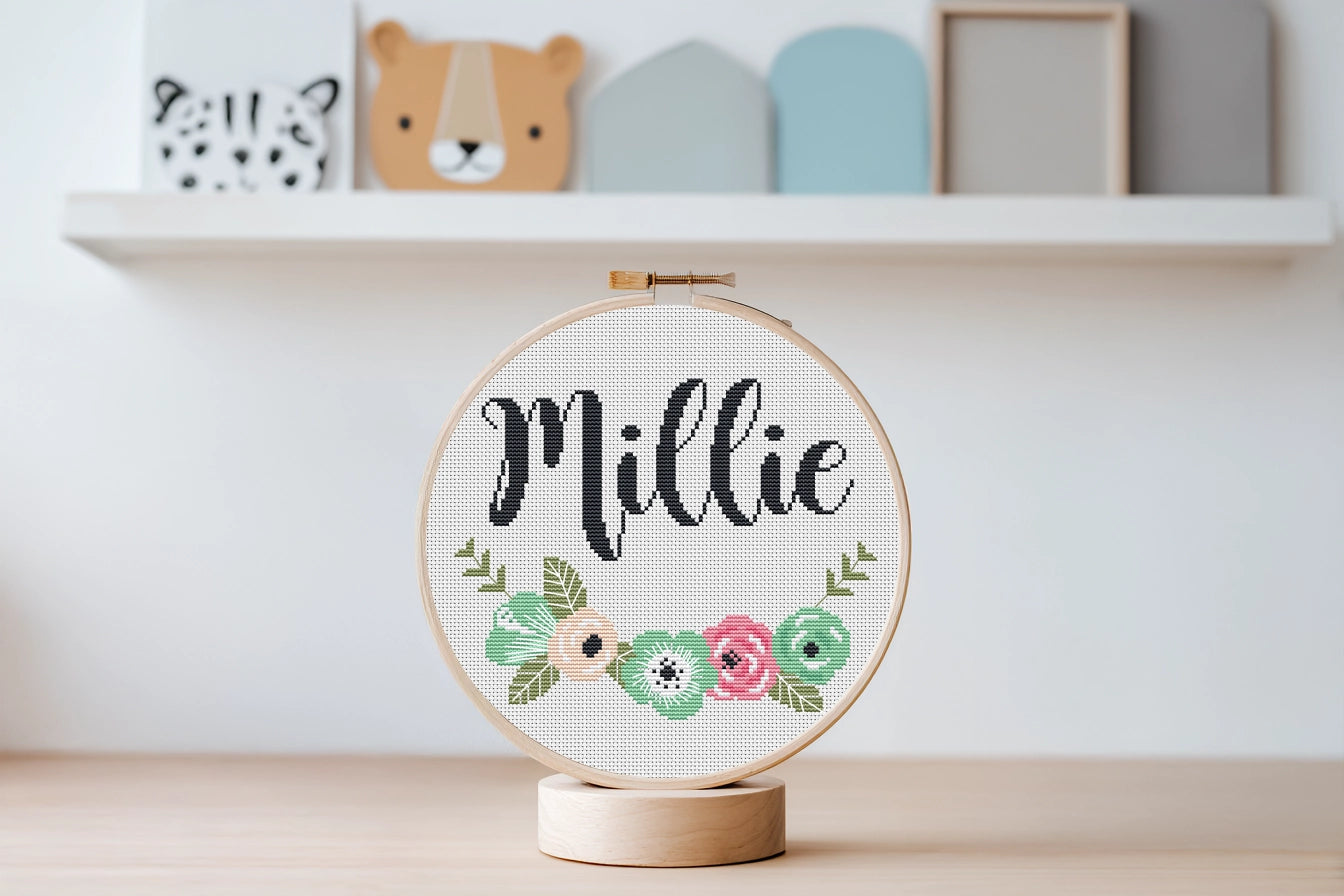 Custom name cross stitch pattern with floral branch below and personalized name on top, minimal floral embroidery design