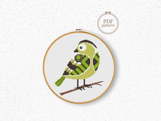 Green bird cross stitch pattern with detailed feathers and elegant nature design