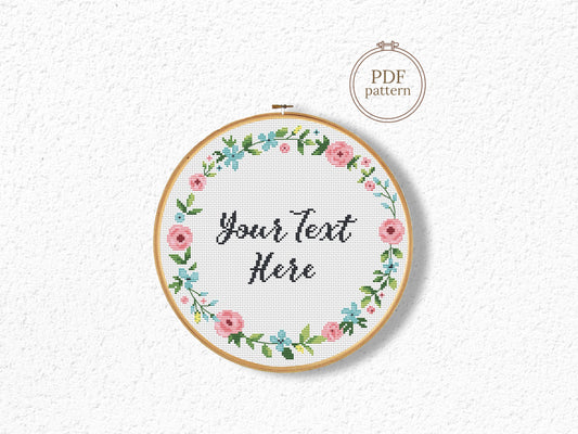 Custom cross stitch pattern with floral wreath and personalized text placeholder - customizable PDF design