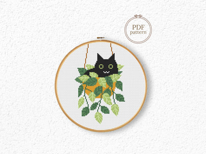 Cute relaxed cat cross stitch pattern sitting in plant pot, peaceful and cozy design