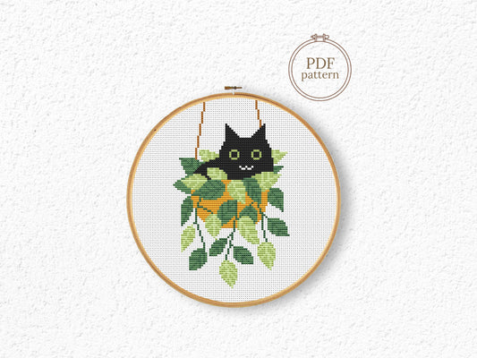 Cute relaxed cat cross stitch pattern sitting in plant pot, peaceful and cozy design