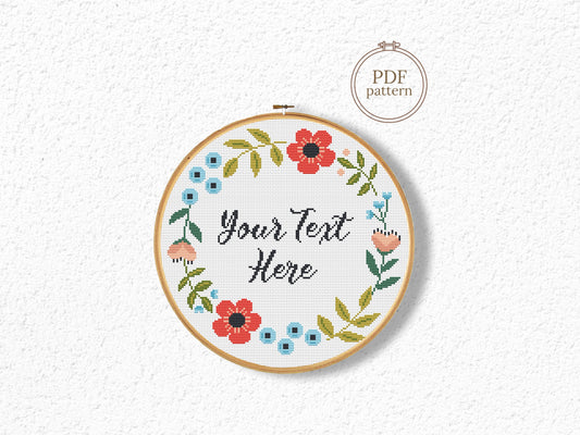 Custom cross stitch pattern with red floral wreath and personalized text placeholder - customizable PDF design