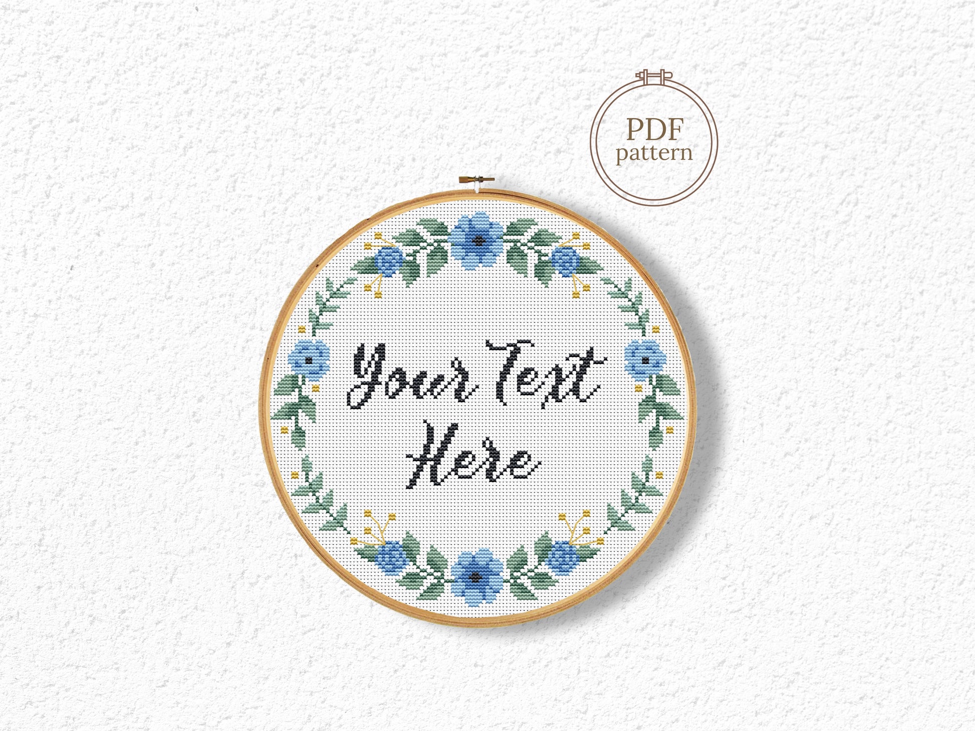 Custom cross stitch pattern with blue floral wreath and personalized text placeholder - customizable PDF design