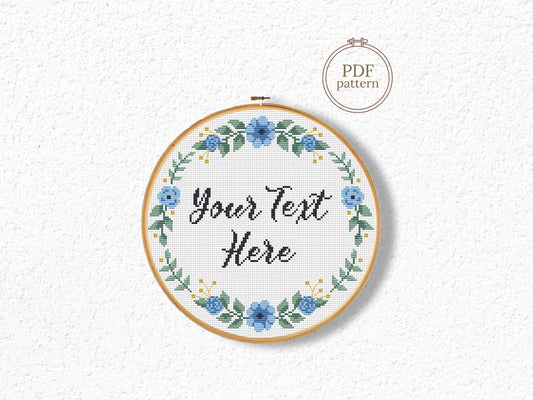 Custom cross stitch pattern with blue floral wreath and personalized text placeholder - customizable PDF design