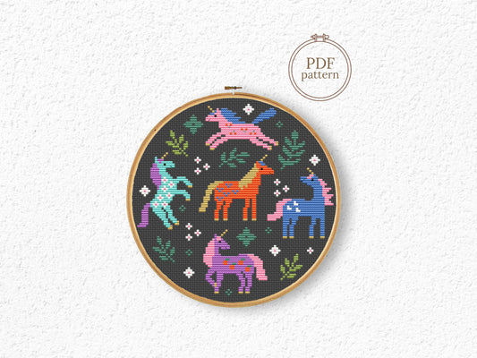 Colorful unicorns surrounded by leaves cross stitch pattern, whimsical fantasy PDF embroidery design.