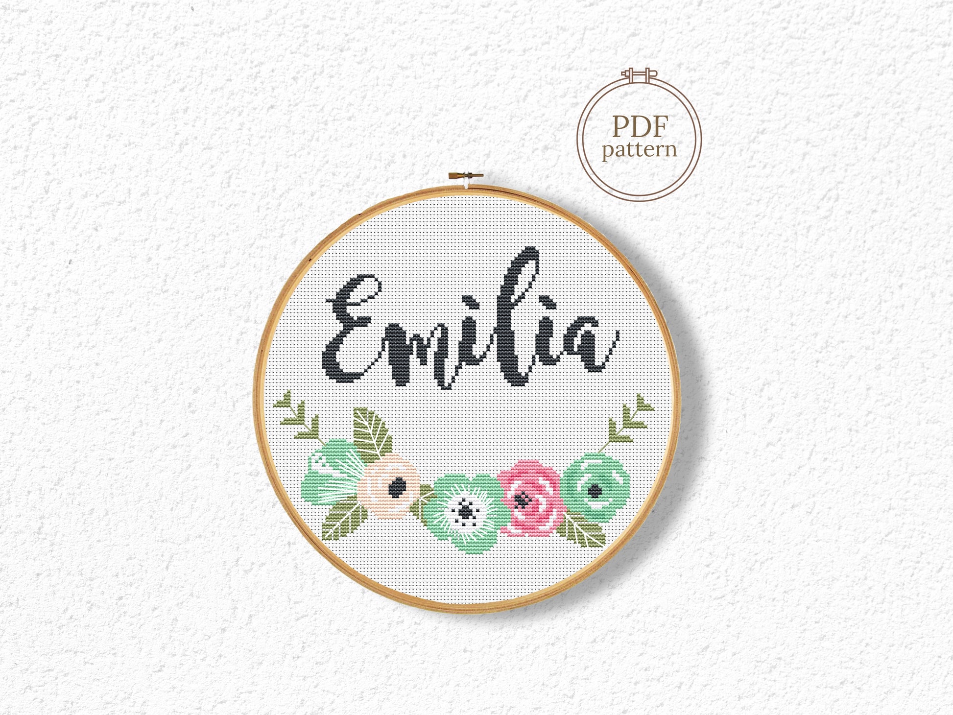 Custom name cross stitch pattern with floral branch below and personalized name on top, minimal floral embroidery design