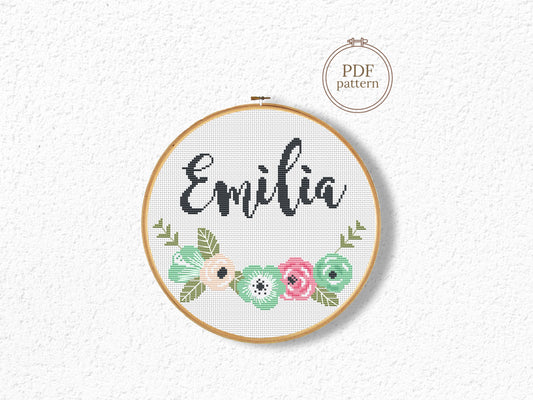 Custom name cross stitch pattern with floral branch below and personalized name on top, minimal floral embroidery design