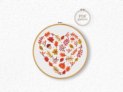 Heart-shaped autumn cross stitch pattern with fall leaves, cozy seasonal PDF design
