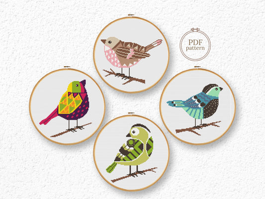 Set of four bird cross stitch patterns with detailed feathers and colorful designs