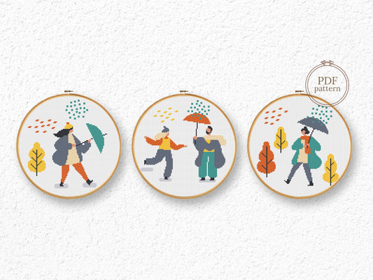 Set of three autumn cross stitch patterns with people, umbrellas, rain, and puddle
