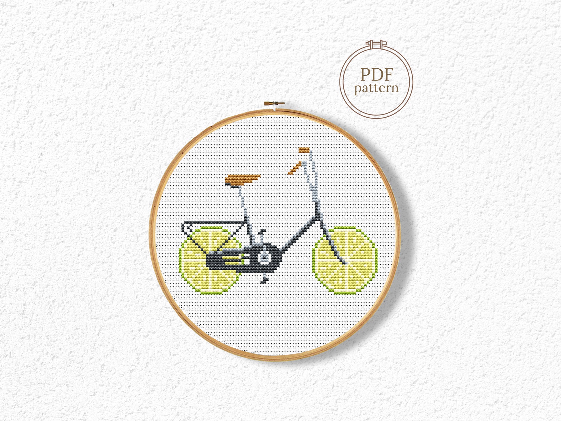 Embroidery hoop with a bicycle design on a white background, featuring the text 'PDF pattern'.
