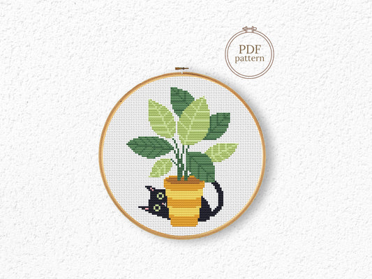 Black cat cross stitch pattern sitting in a flower pot, cozy and expressive design