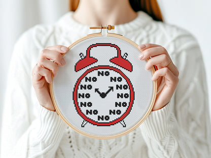 Funny alarm clock cross stitch pattern with playful design