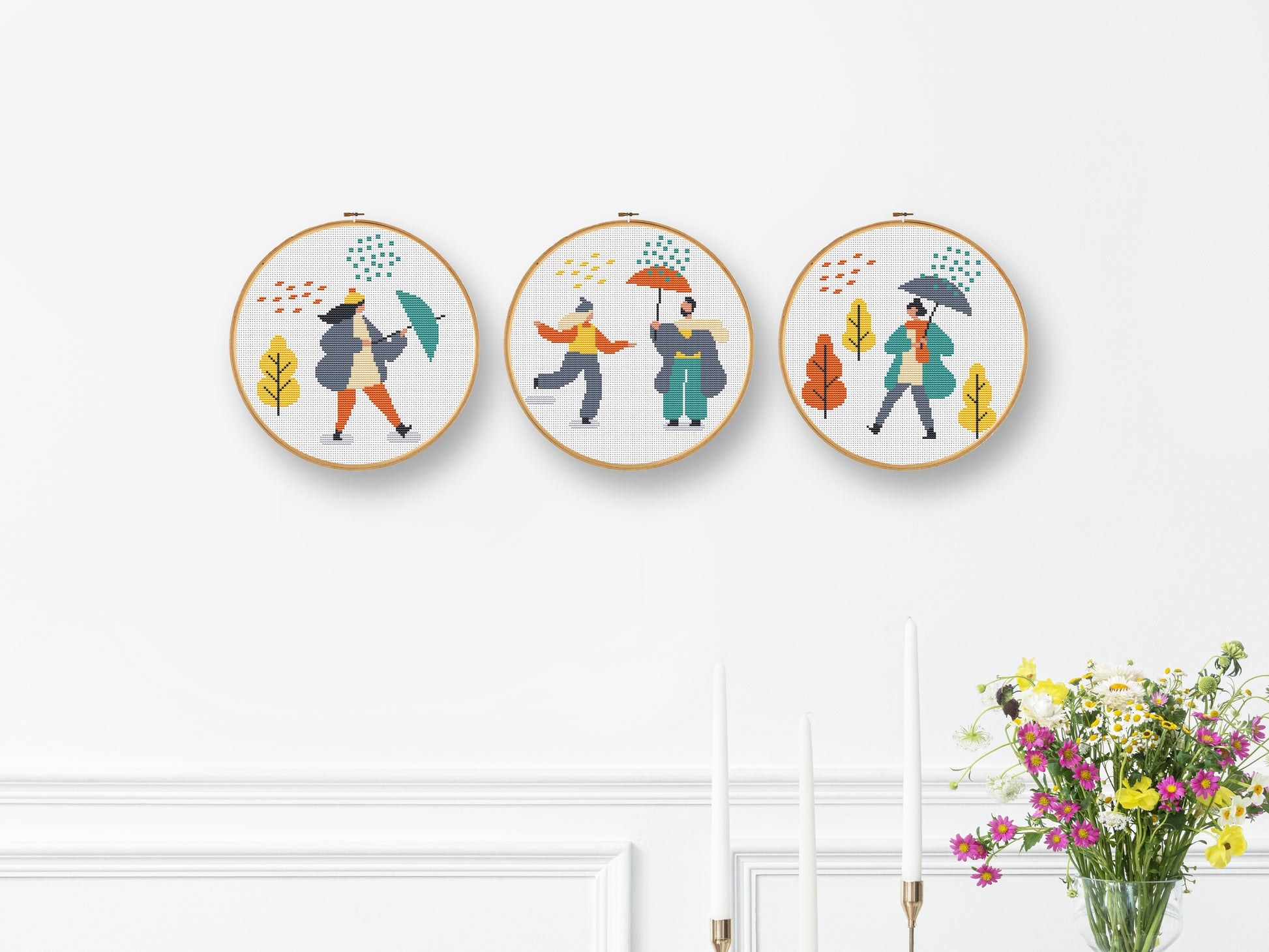 Set of three autumn cross stitch patterns with people, umbrellas, rain, and puddle