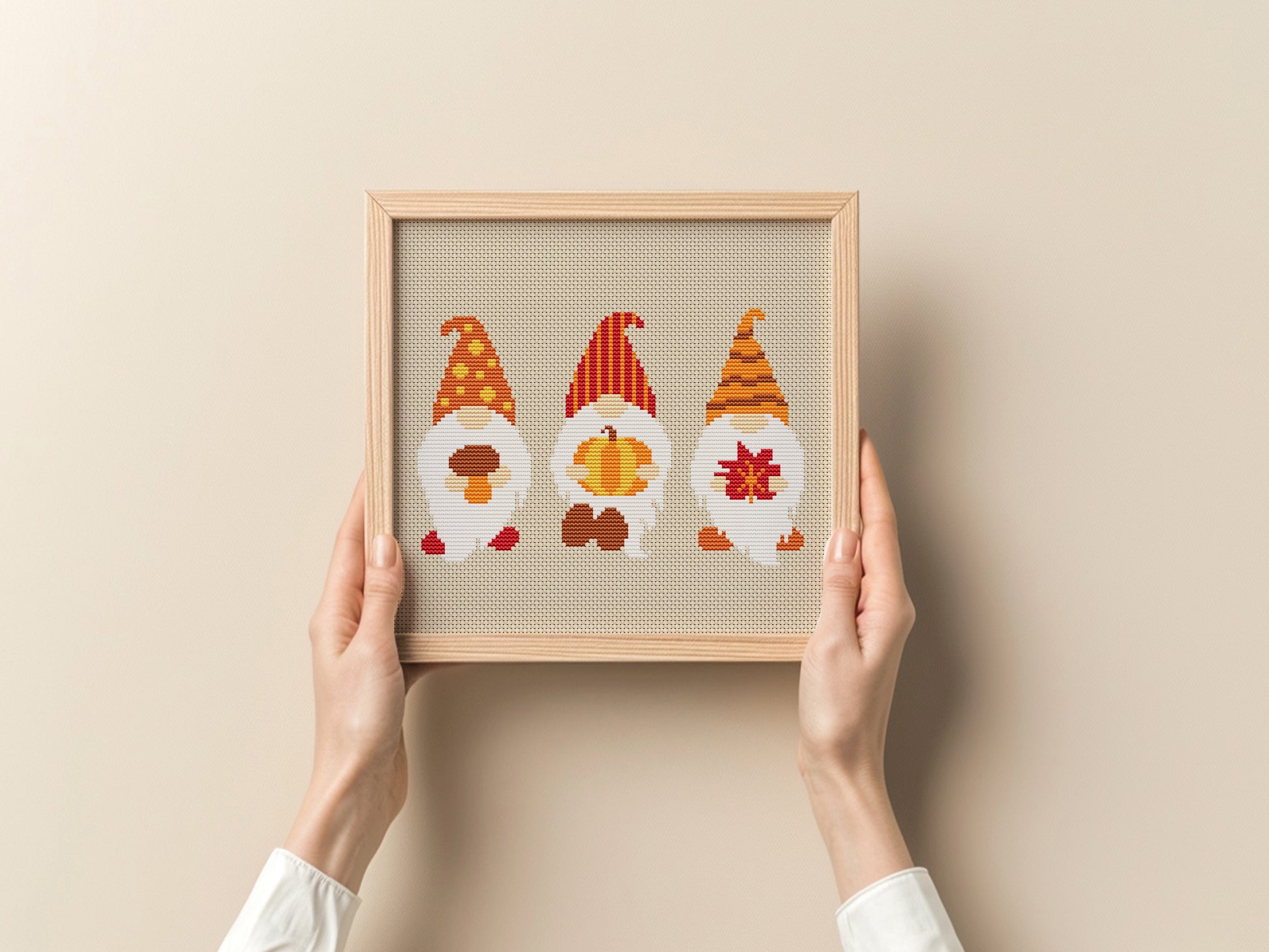 Framed artwork with three gnomes on a beige background
