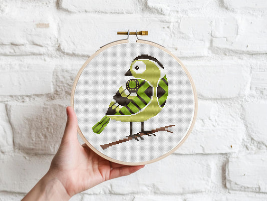 Green bird cross stitch pattern with detailed feathers and elegant nature design
