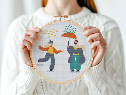 Set of three autumn cross stitch patterns with people, umbrellas, rain, and puddle