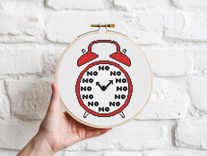 Funny alarm clock cross stitch pattern with playful design