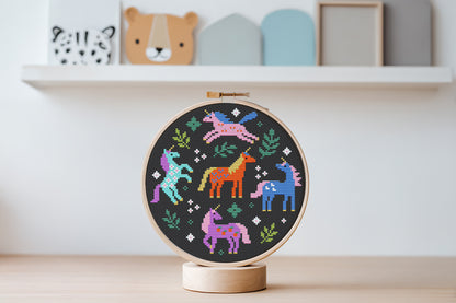 Colorful unicorns surrounded by leaves cross stitch pattern, whimsical fantasy PDF embroidery design.