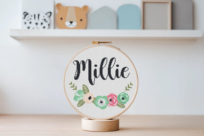 Custom name cross stitch pattern with floral branch below and personalized name on top, minimal floral embroidery design