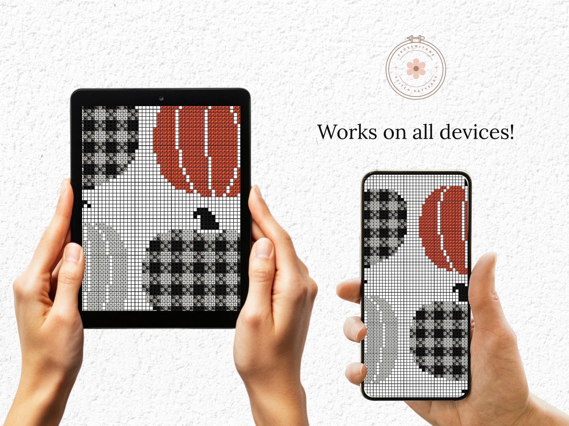 Hands holding a tablet and phone displaying cross-stitch patterns of pumpkins and leaves.