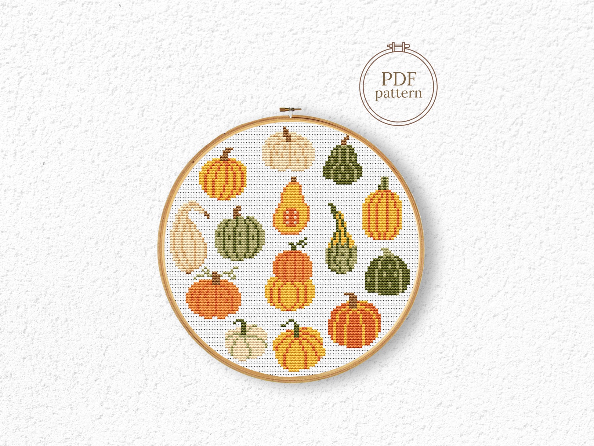 Fall cross stitch pattern with colorful pumpkins in different shapes and autumn shade